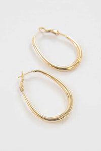 Gold Oro Hoop Earrings close-up on neutral background