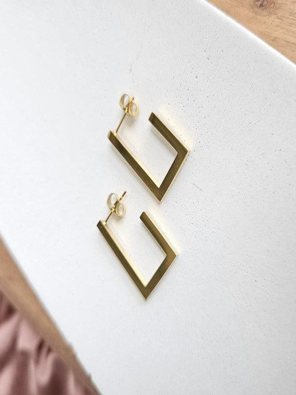 Everyday gold earrings worn by mom on-the-go
