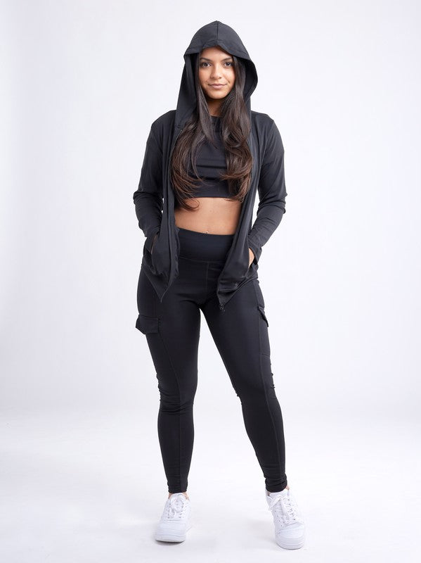 Model wearing a zip-up hoodie jacket styled with high-waisted leggings for a sporty look