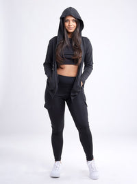 Model wearing a zip-up hoodie jacket styled with high-waisted leggings for a sporty look