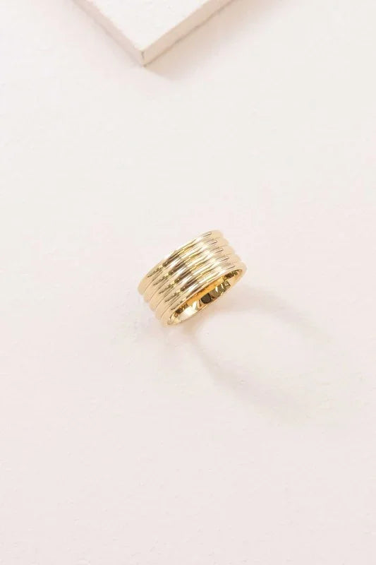Boldly Gold Ring – wide 14K gold stainless steel statement ring on neutral background