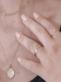 Gold Lady Gisela Necklace layered with other dainty gold necklaces